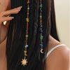 A long black hair strand adorned with a bohemian sun moon tassel hair headdress