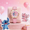 A pink wrist watch featuring a colorful dial and Stitch character on the face, resting on a pink fabric with Stitch figures.