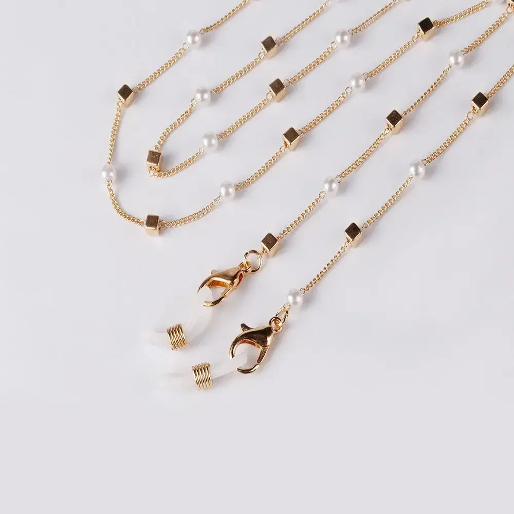 Gold chain lanyard with pearl beads and a clear charm for sunglasses