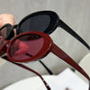 A close-up view of a pair of trendy leopard cat eye sunglasses in dark brown and black frames.