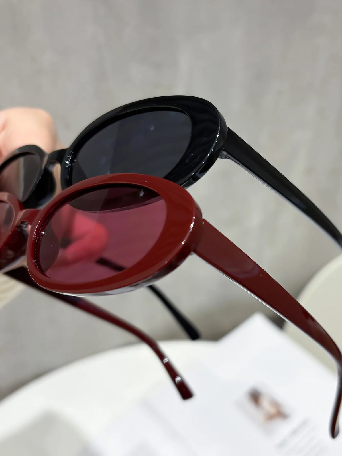 A close-up view of a pair of trendy leopard cat eye sunglasses in dark brown and black frames.
