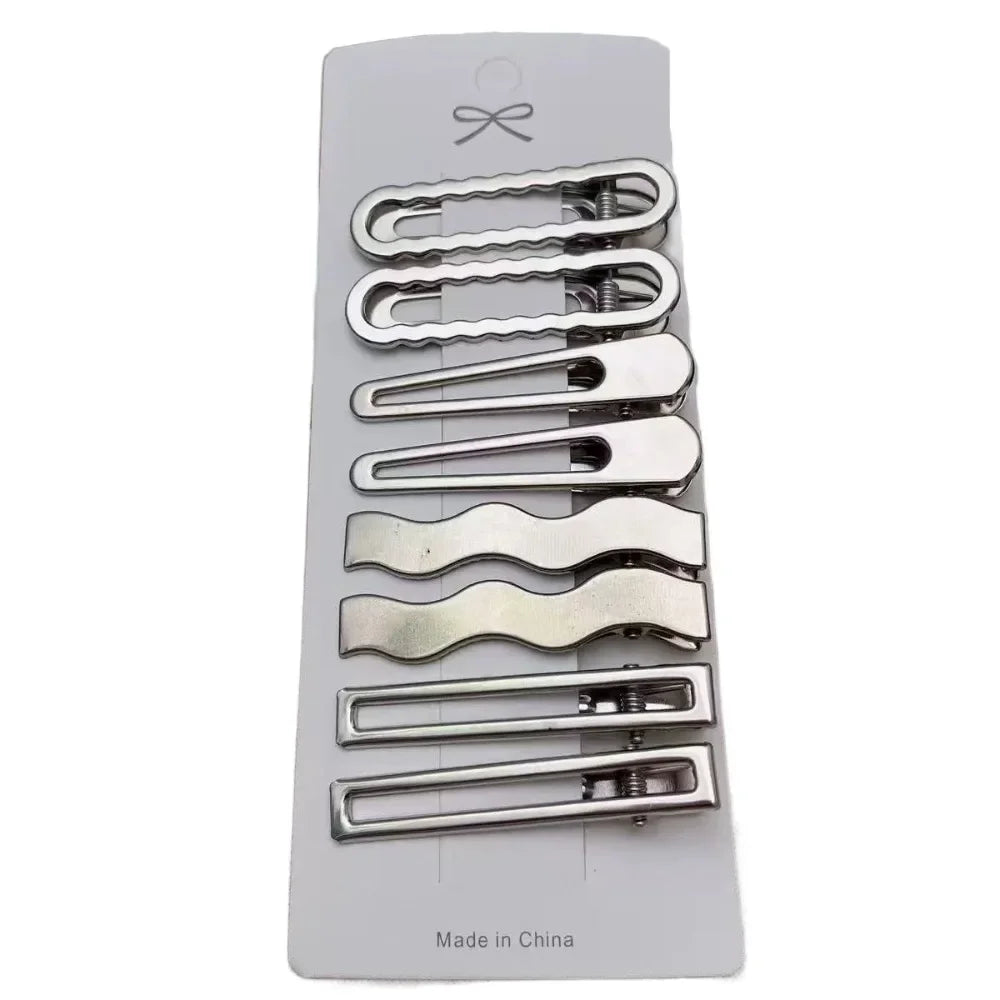 A set of vintage silver Y2K metal hair clips with various shapes and sizes displayed on a white background.