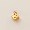 A gold plated butterfly key pendant charm resting on a neutral background.