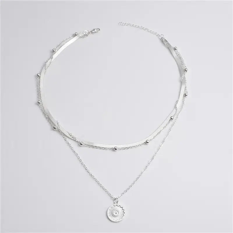 Silver stainless steel necklace with a delicate chain and a round zircon cross pendant