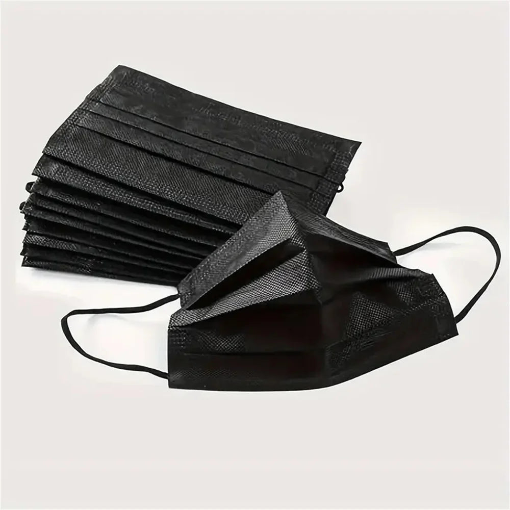 A stack of black disposable face masks for adult protection.