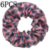 Seis gomas de tela satinada con estampado floral en tonos rosa y azul.