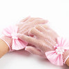 Pink bridal mesh finger gloves with floral accents shown on a hand.