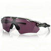 Purple polarized cycling sunglasses with a black frame resting on a white surface.