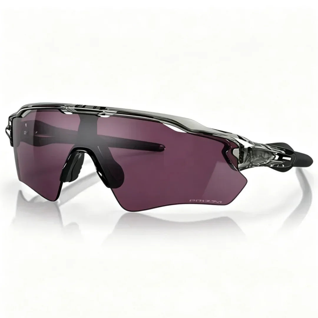 Purple polarized cycling sunglasses with a black frame resting on a white surface.
