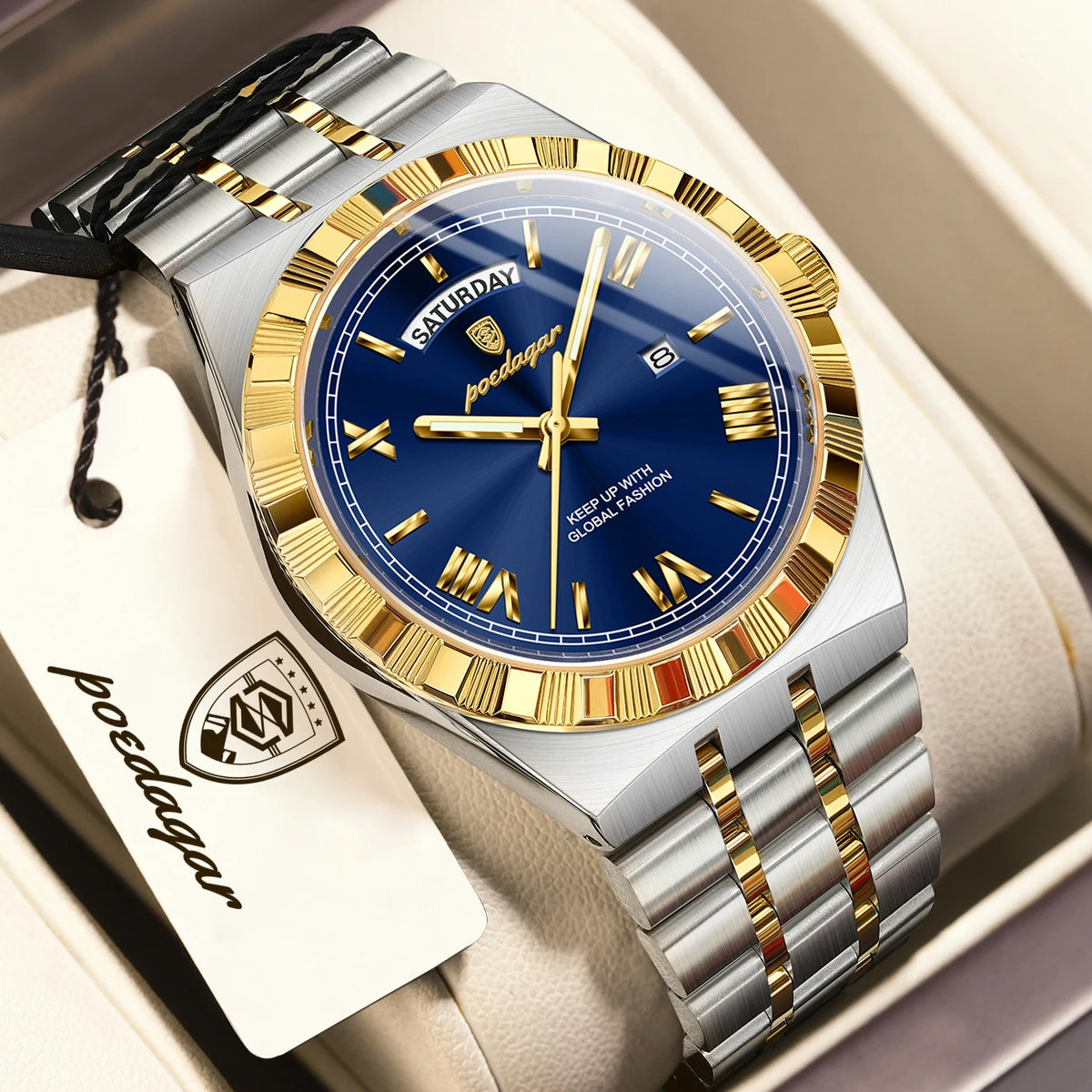 A silver and gold watch with a blue dial and gold accents is displayed in a box.