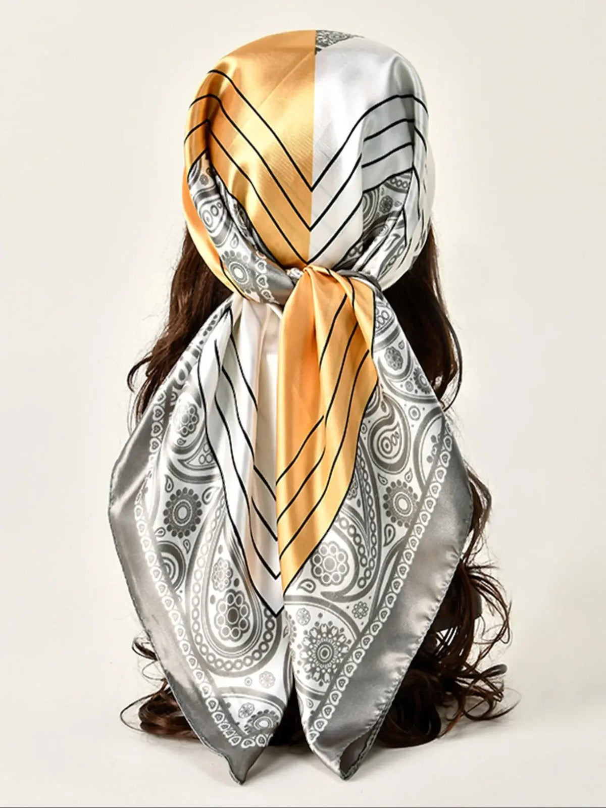 Elegant floral satin shawl tied around a dark brown hairstyle, featuring gold and silver stripes.