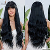 A woman models a long, black, wavy wig with bangs against a white background.