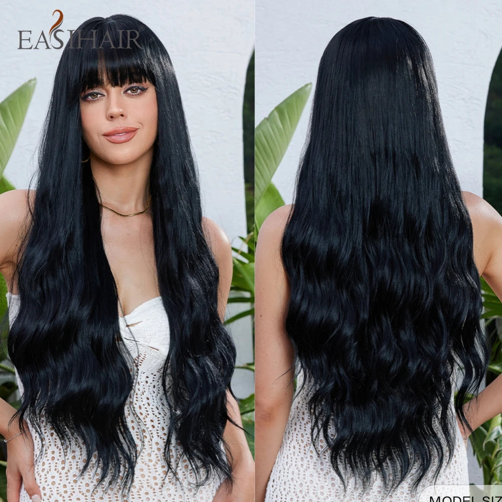 A woman models a long, black, wavy wig with bangs against a white background.