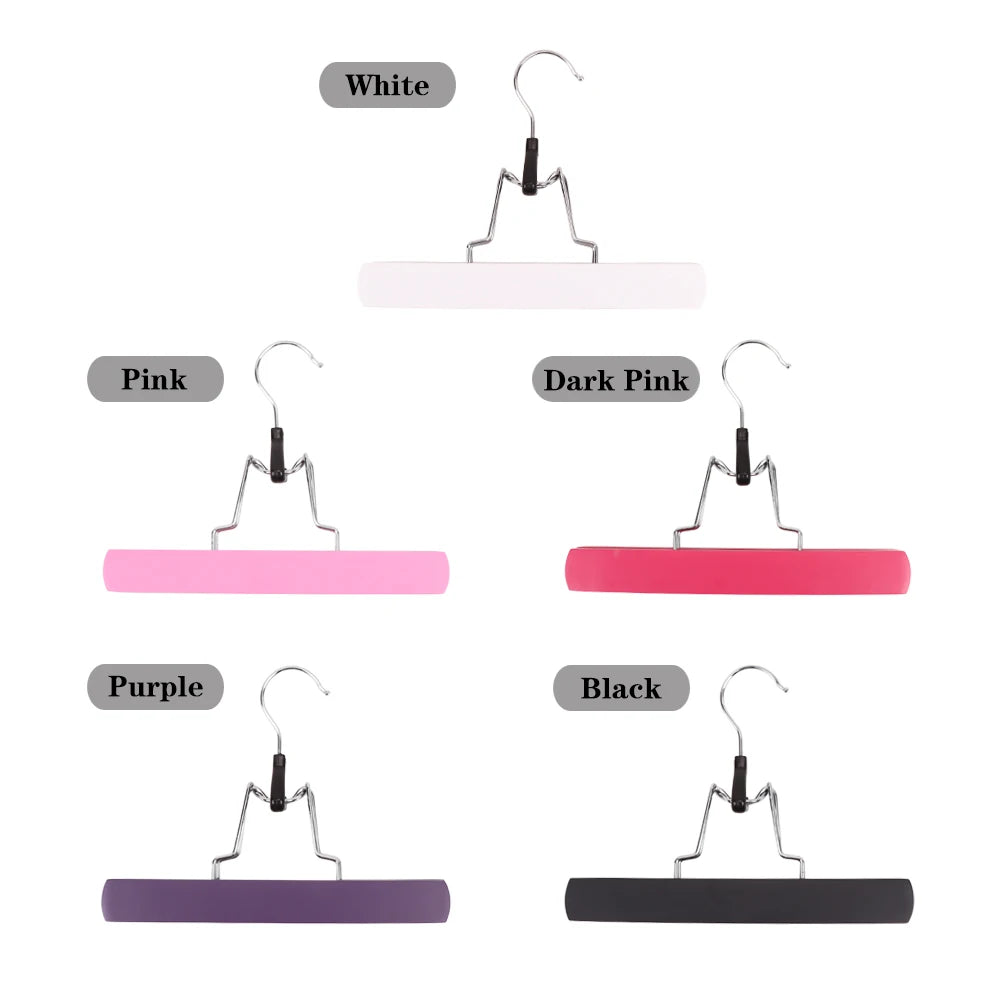 A set of wooden wig and hair extension holders in white, pink, purple, and black colors.