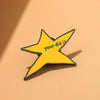 A yellow star-shaped enamel pin with the text you did it on a light orange background.