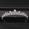 A sparkling crystal rhinestone bridal tiara headpiece displayed on a dark surface.