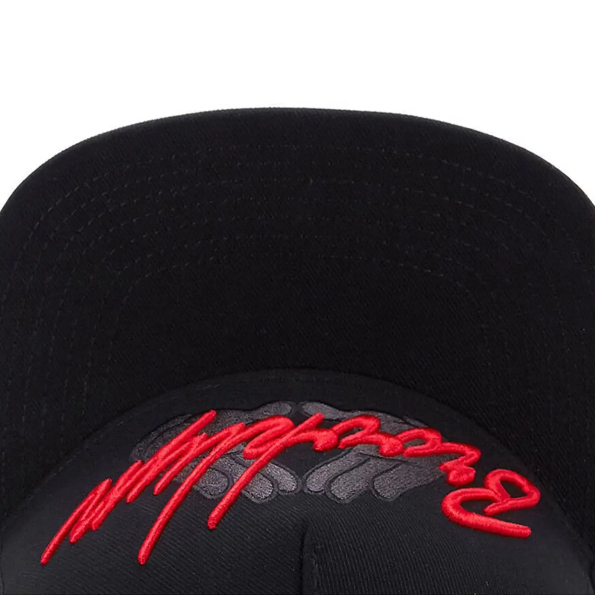 Black snapback cap with red embroidered text on the front