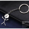 Silver chain keychain featuring a stickman making the middle finger gesture on a dark surface.