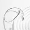 A close-up of a silver gold droplet arm bangle with an adjustable design, shown against a bright white background.