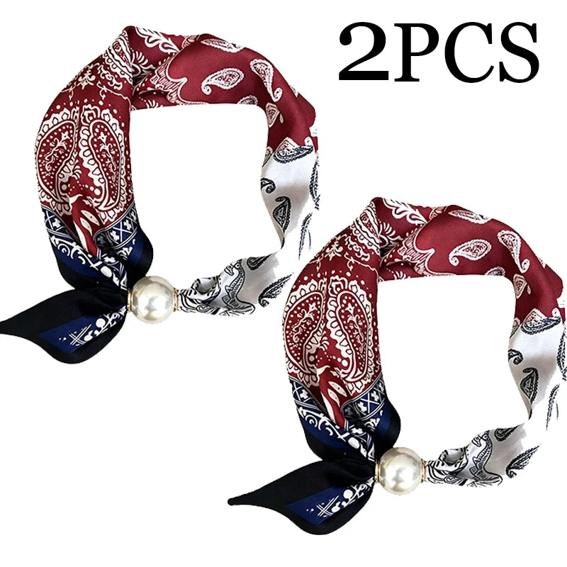 Two pieces of red and white paisley patterned silk scarves with pearl tail magnetic clasps