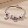 A silver and pink beaded love bracelet set featuring various charms including hearts and flowers.