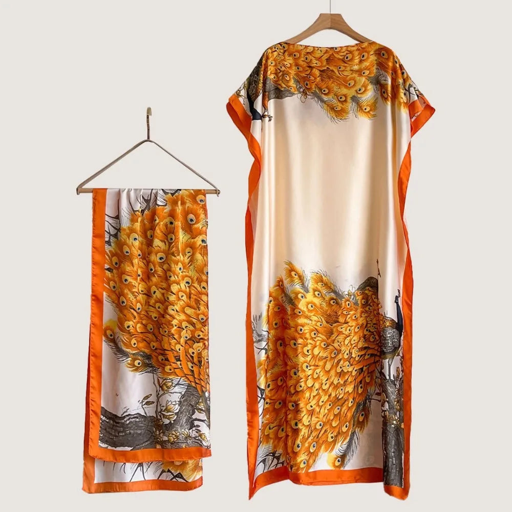 A long, flowing cape shawl featuring a detailed print of golden yellow floral butterflies and peacock feathers on a cream bac