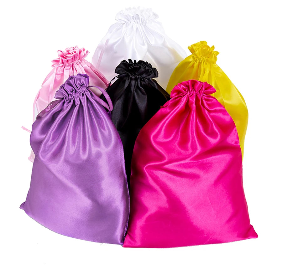 A collection of colorful satin wig storage bags including purple, pink, black, and yellow.