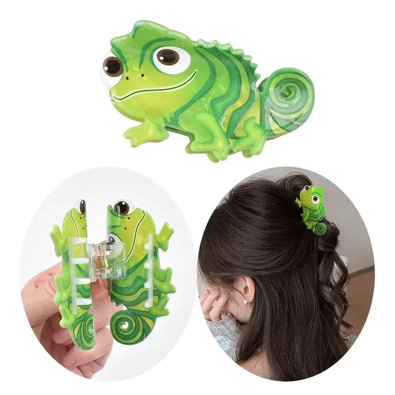 A bright green lizard-shaped hair clip accessory being held by a hand.