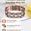 A close-up of a rose gold copper bracelet featuring sparkling crystal designs and magnetic links.