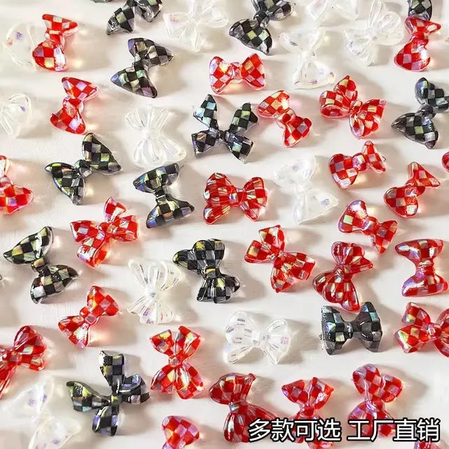 A collection of 10 resin nail art charms in various colors and shapes, including bows and flowers.