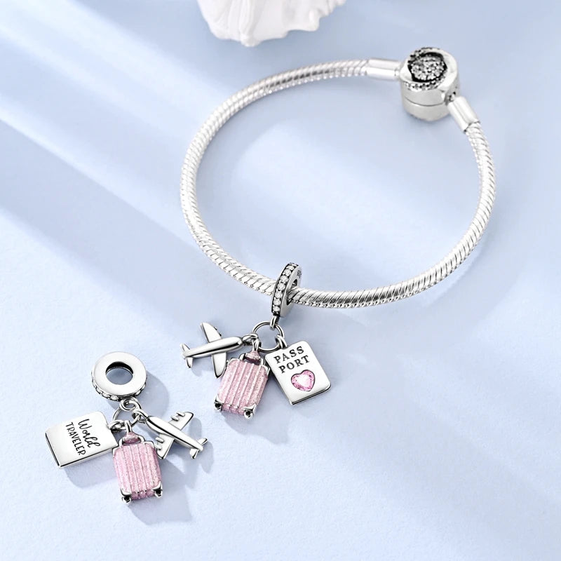 Sterling silver charm bracelet featuring a pass port and luggage tag charms