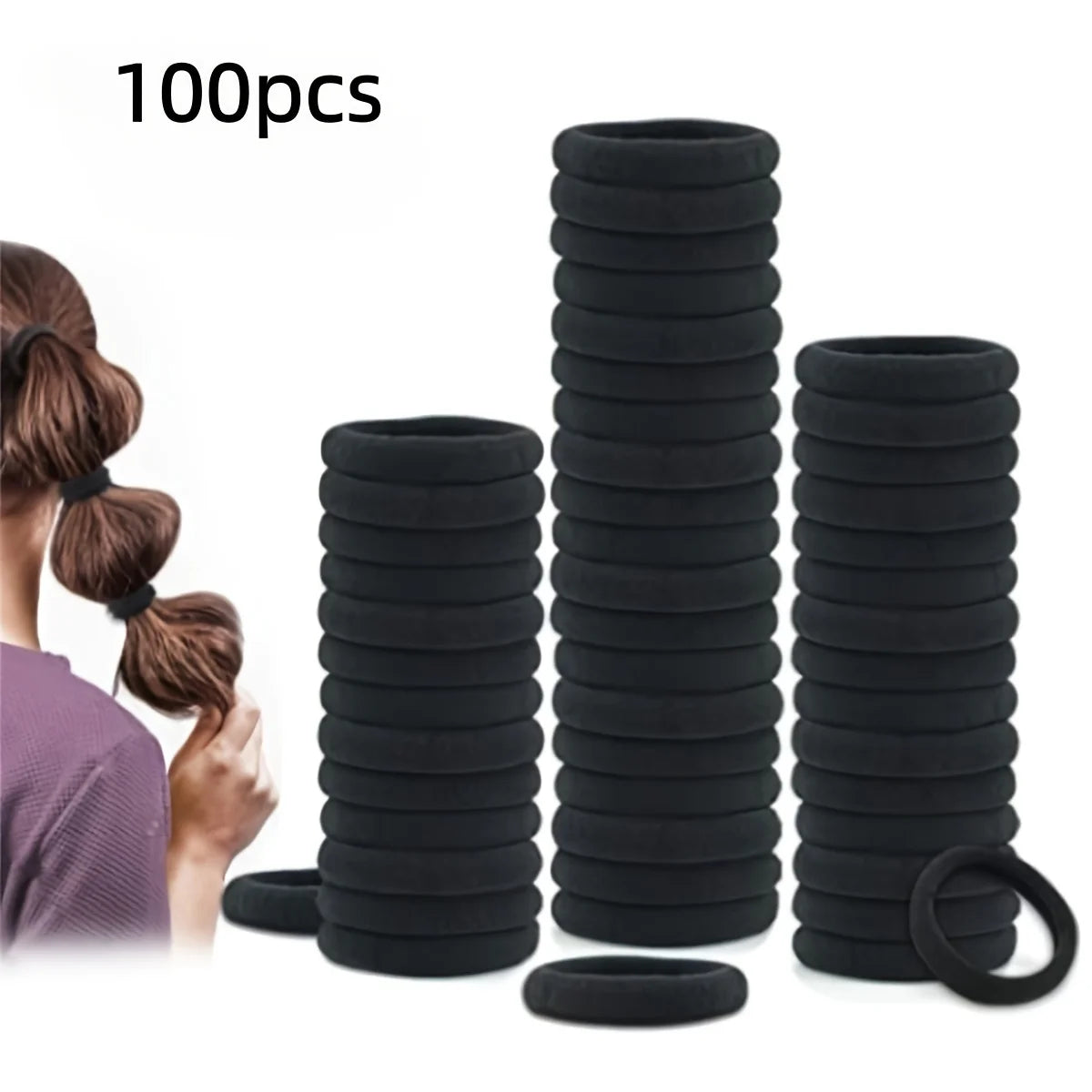 A stack of black seamless elastic hair ties and a single black rubber band are shown next to a person's hair.