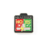 A black enamel brooch pin featuring the text NO YES and a lightning bolt symbol on a green background.