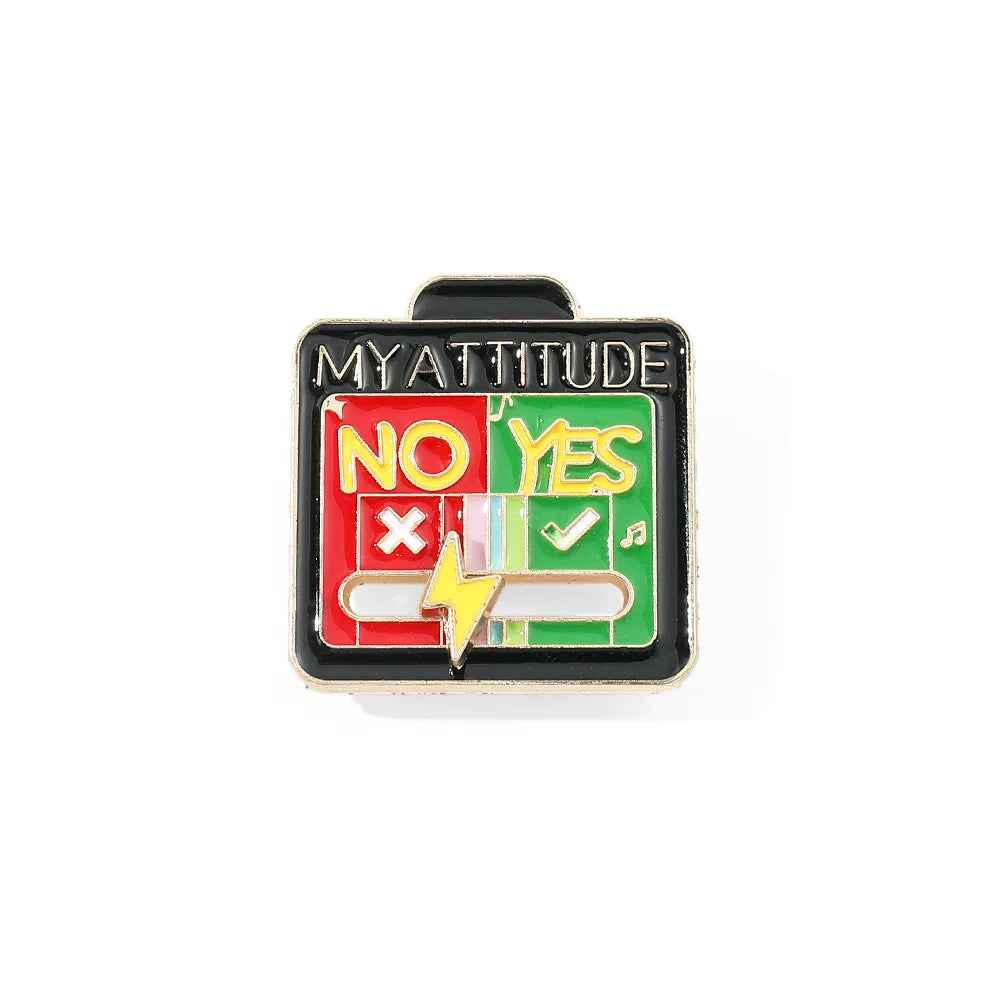 A black enamel brooch pin featuring the text NO YES and a lightning bolt symbol on a green background.