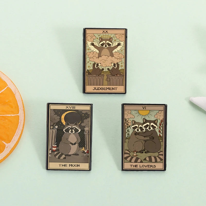 A set of three tarot card enamel pins featuring woodland animals and symbolic imagery on a light green background.