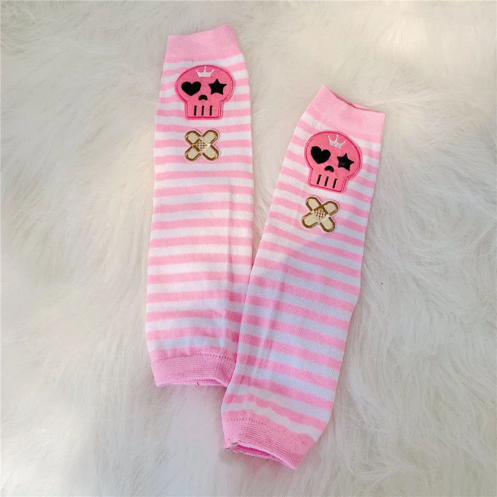 Pink striped fingerless gloves featuring skull and cross motifs for Y2K grunge accessories