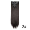 A bundle of long, straight, black hair extensions with small barrettes attached.