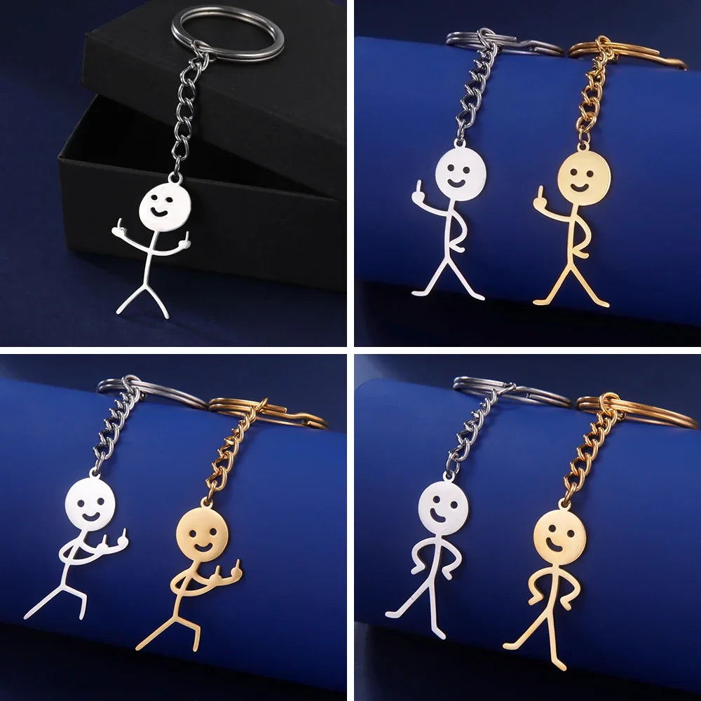 A set of funny stickman middle finger keychains in gold and white on dark blue backgrounds.