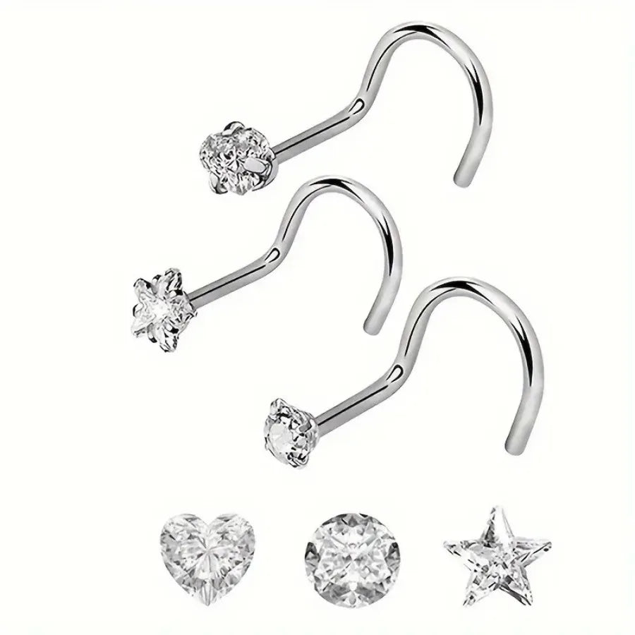 Three pieces of zirconia nostril studs including a curved bar and a heart and star shape.