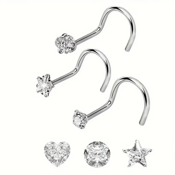 Three pieces of zirconia nostril studs including a curved bar and a heart and star shape.