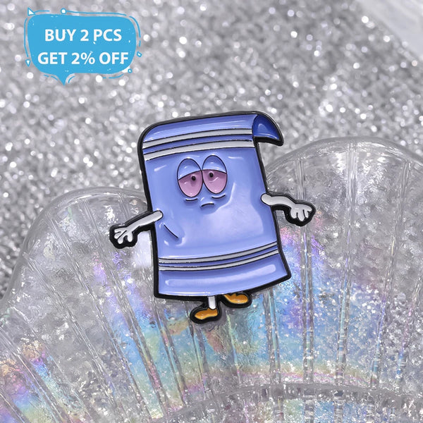 A purple cartoon enamel pin shaped like a shirt with blue stripes is displayed on a clear, textured surface.