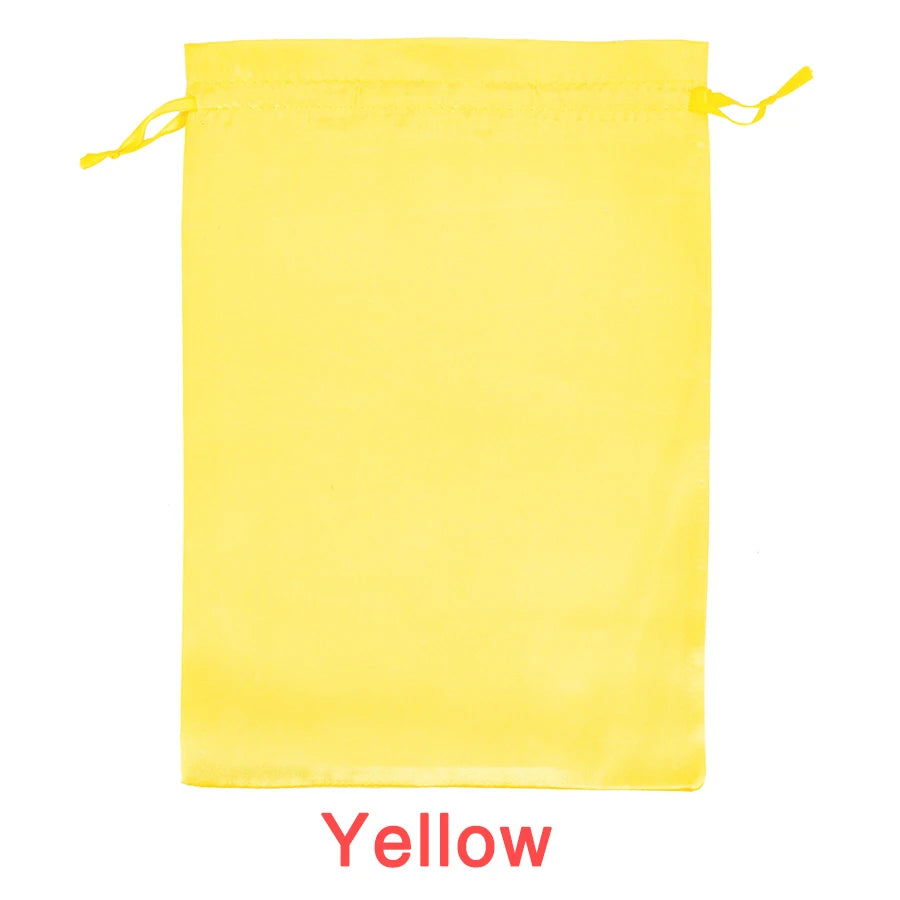 A bright yellow satin wig storage bag with a drawstring closure.