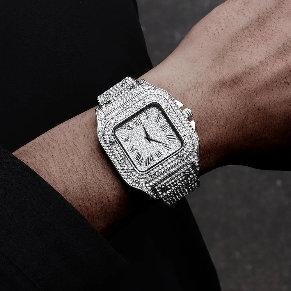 A close-up of a diamond-encrusted men's quartz business watch worn on a wrist against a dark background.