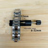 A silver watch band with a black adjustment mechanism is shown on a wooden surface.