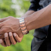 A person's hand is wearing a pure copper magnetic bracelet on their wrist.