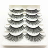 A display of several pairs of black mink false eyelashes arranged on a white plastic tray.