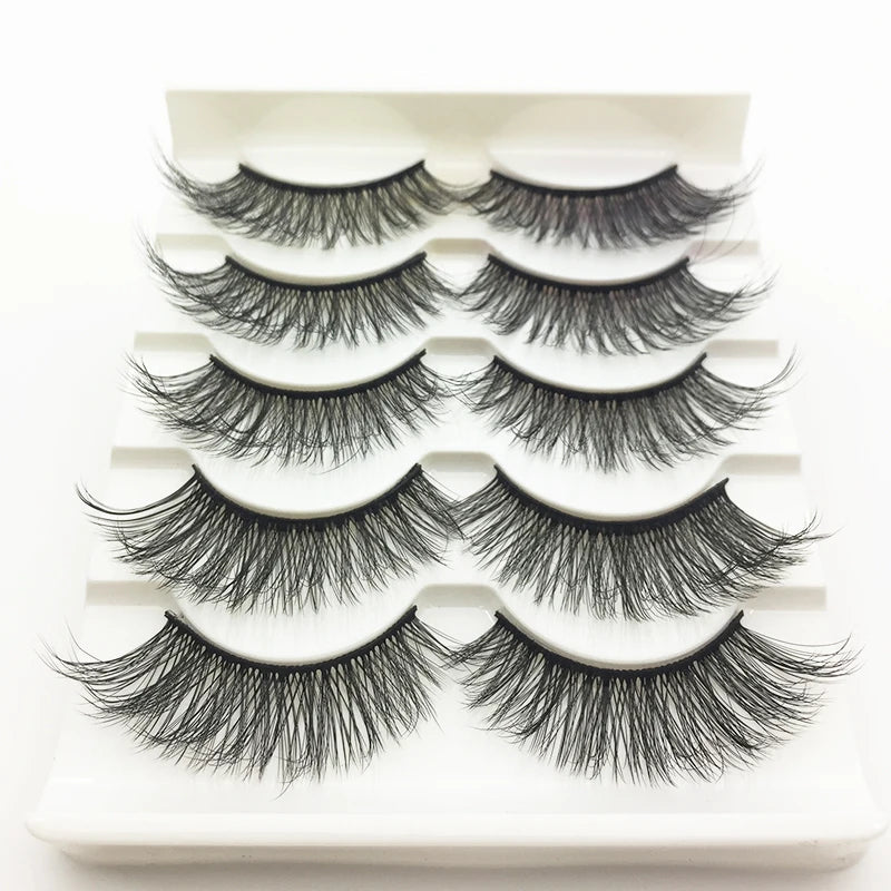 A display of several pairs of black mink false eyelashes arranged on a white plastic tray.