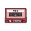A vintage red cassette tape enamel pin brooch with a rectangular design and audio symbols.