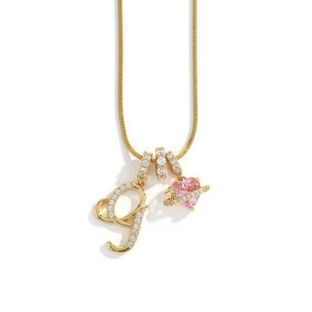 A gold-toned alphabet flower pendant necklace featuring a letter Y and a pink gemstone.