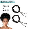 A pair of black satin hair ties or scrunchies are shown next to a woman's head.
